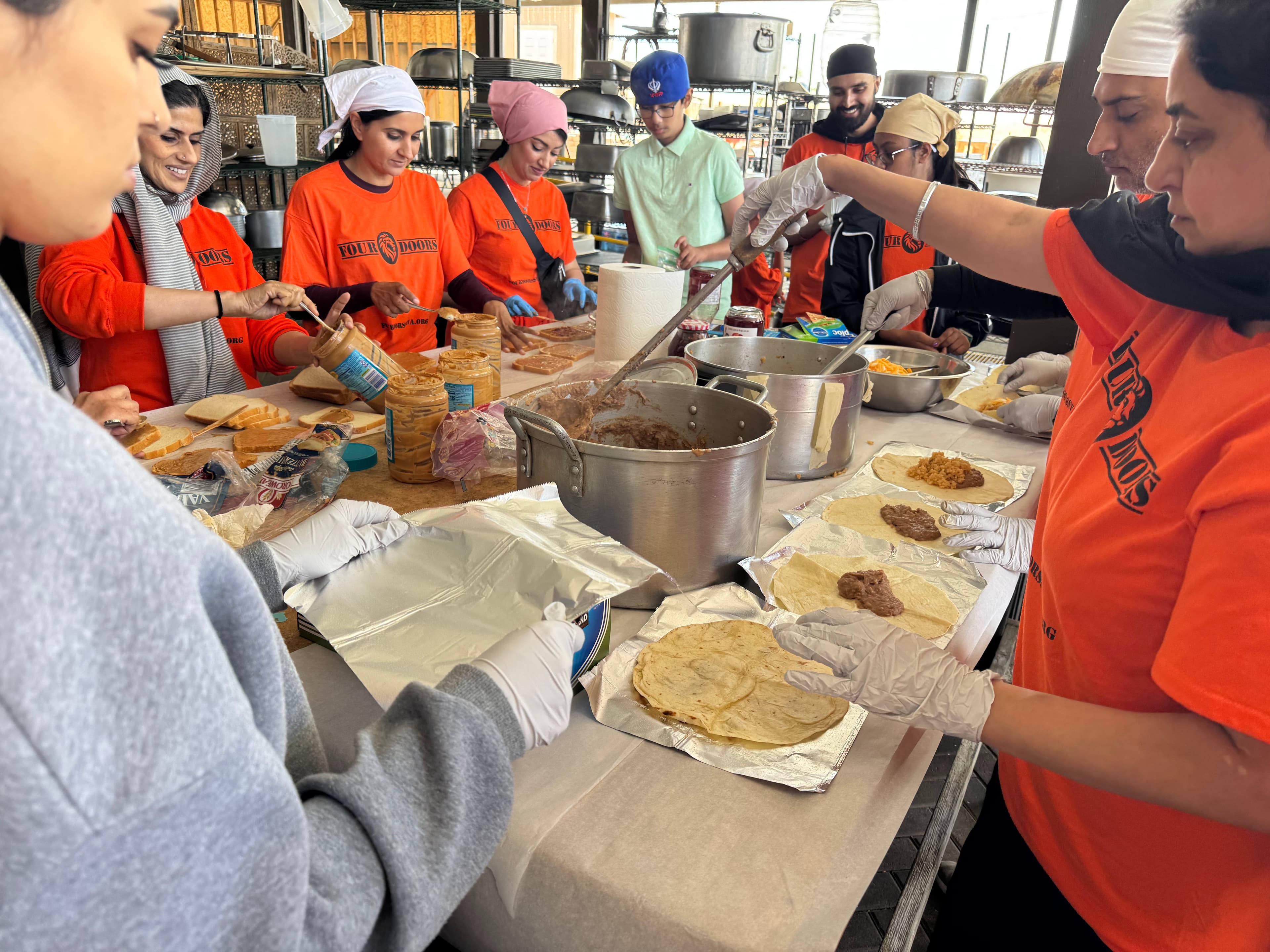 Four Doors volunteers preparing meals in the kitchen